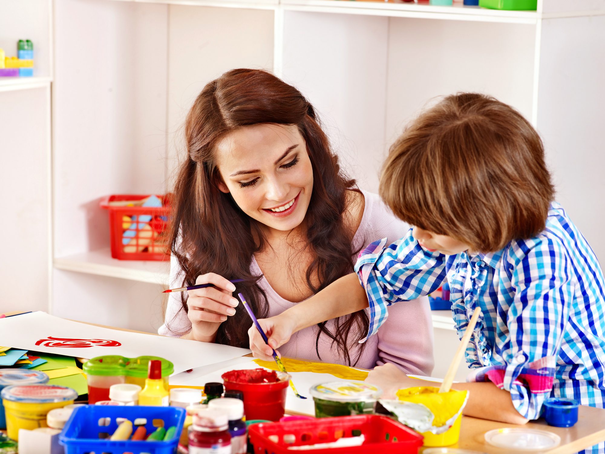 A mother and son using watercolor to paint