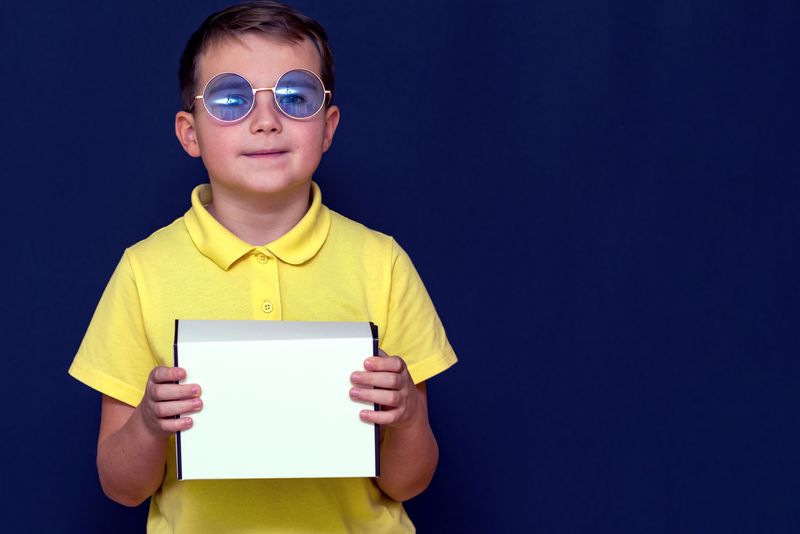 boy in color blind correction glasses