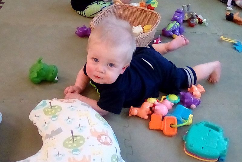 An infant doing tummy time at Meadow Montessori School in South Richmond TX