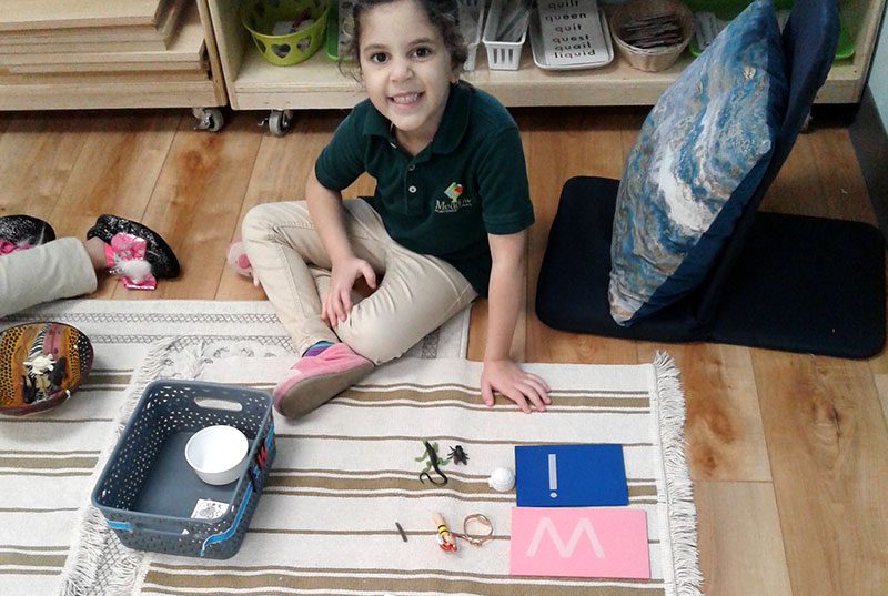 A student working with letters at Meadow Montessori School in South Richmond, TX