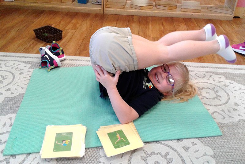 A young girl doing stretches at Meadow Montessori School in South Richmond, TX