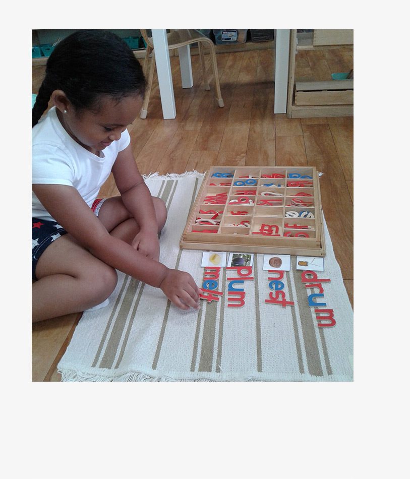 A young girl spelling out different words