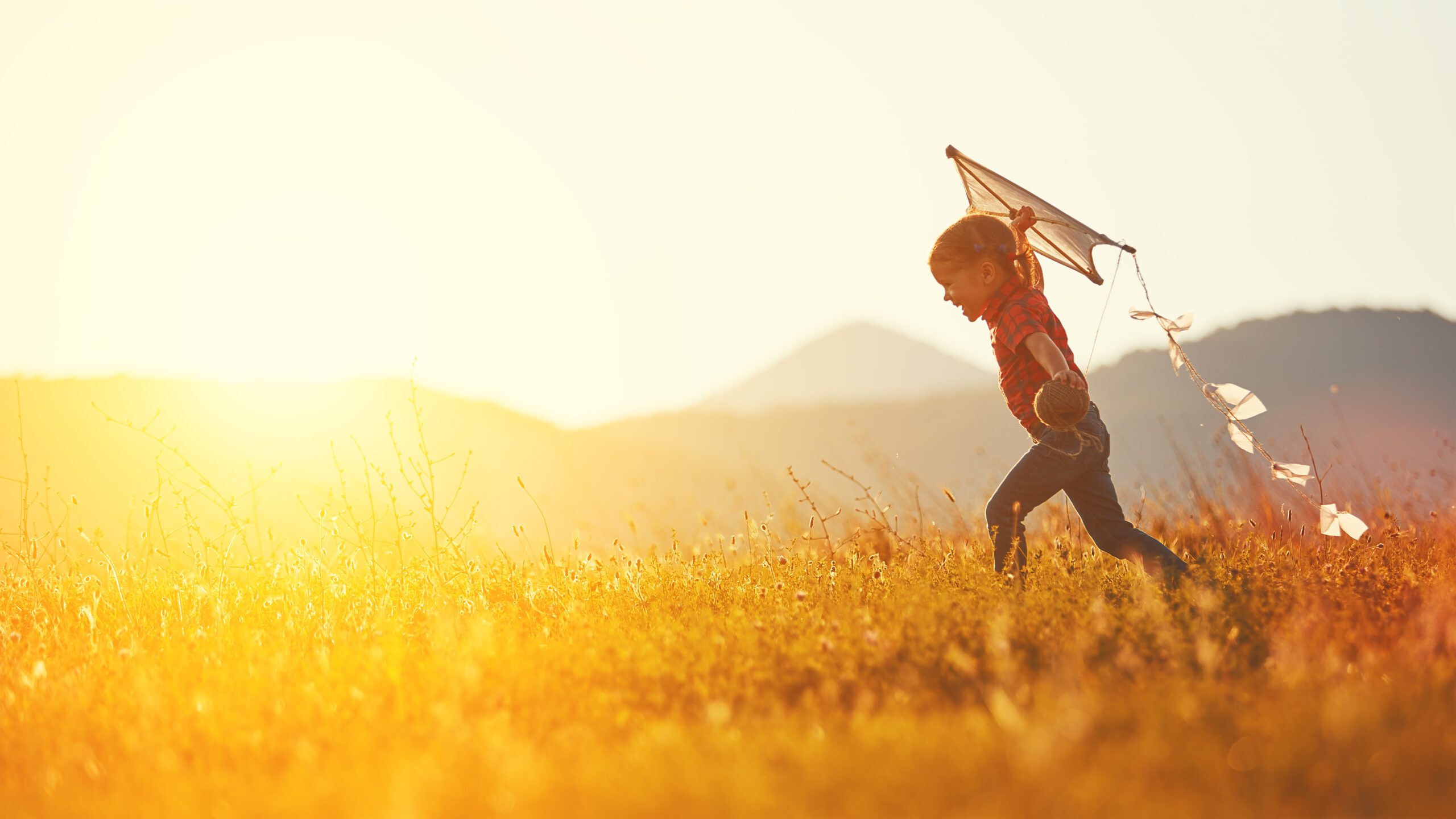 independent child flying a kite