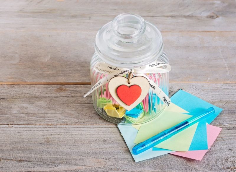 A gratitude jar filled with different pieces of paper