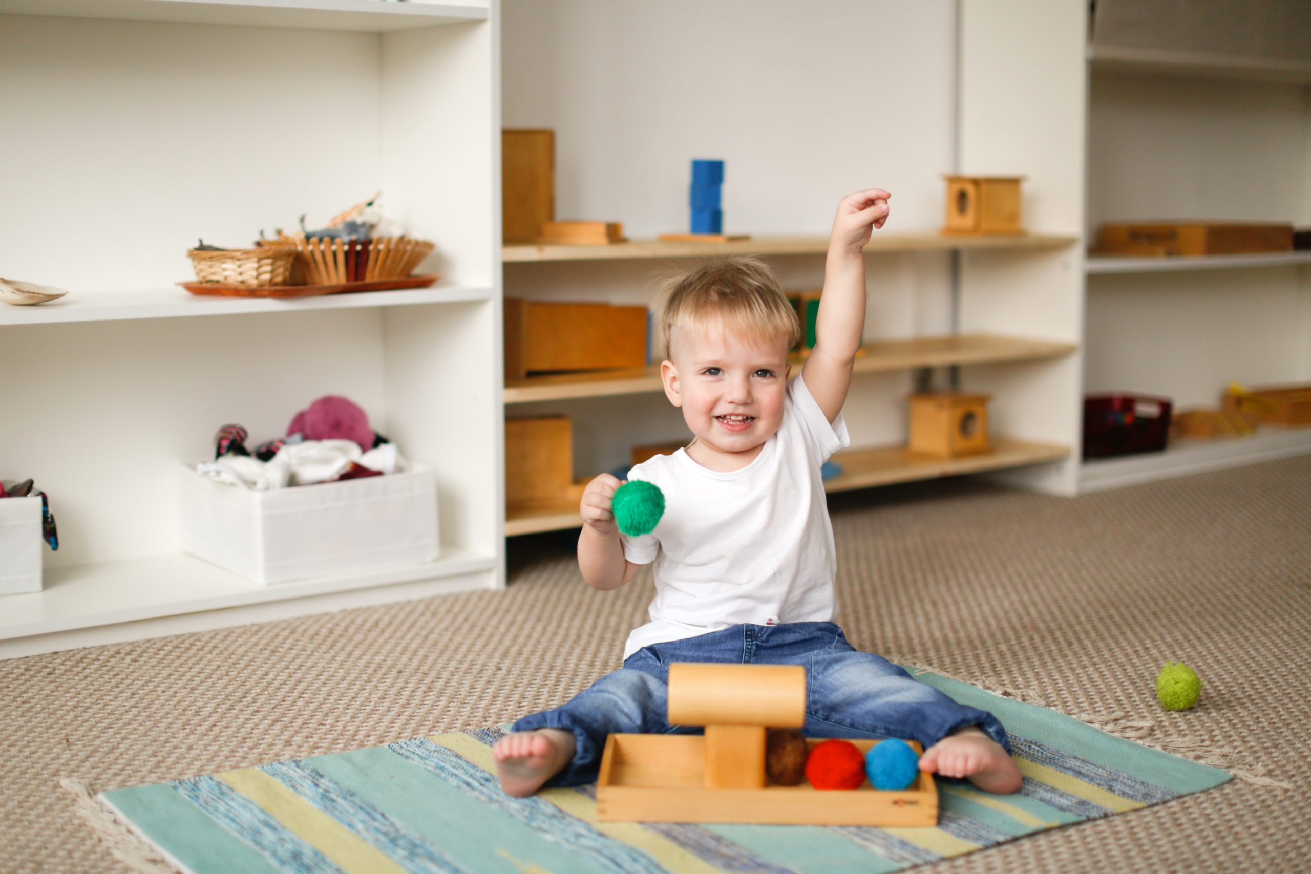 A young child playing Montessori toys