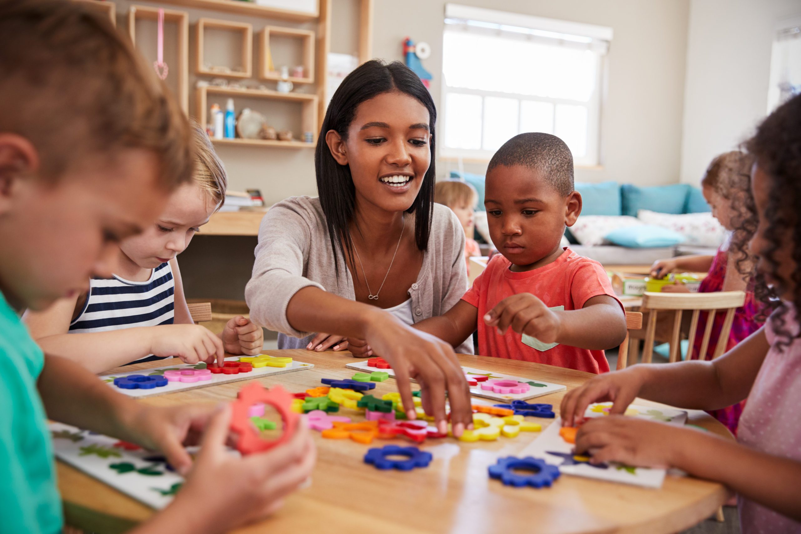 children and teacher learning in a montessori school