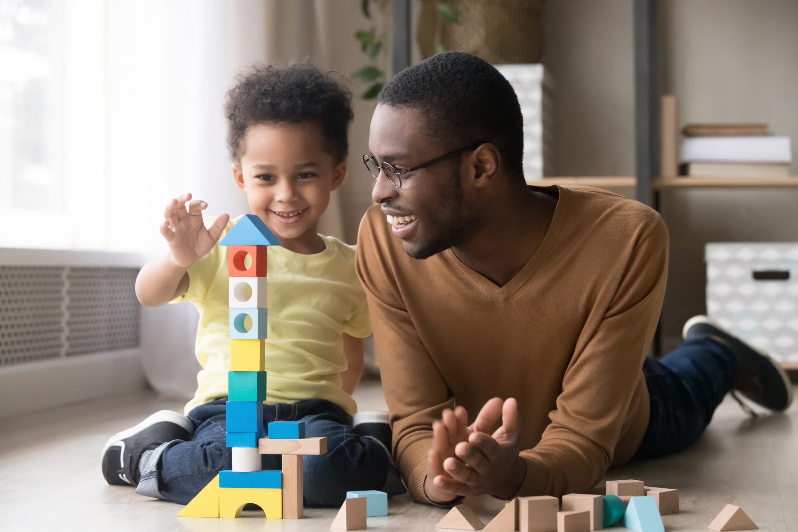 father and son playing with building blocks