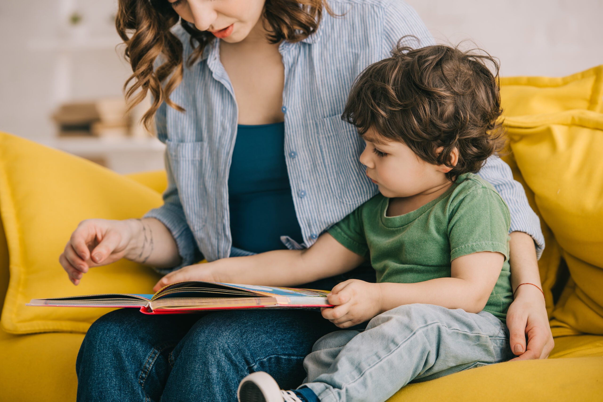 Mother and son reading together on the couch