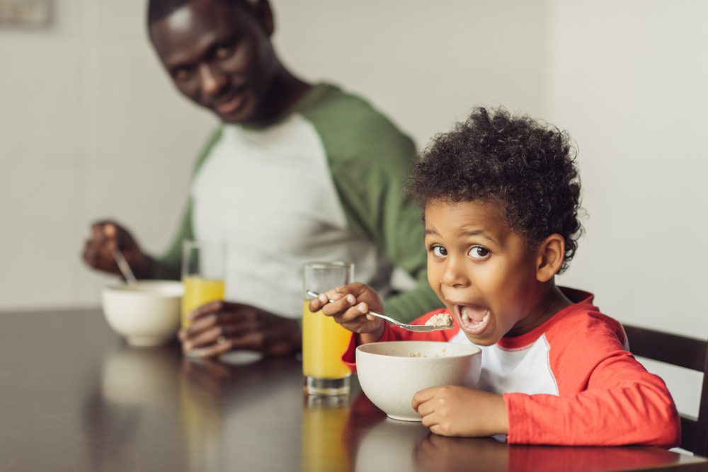 Africa American father and son eating a nutritious breakfast